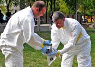 Two men holding radiology material